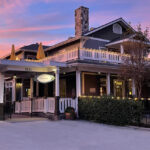 Beautiful image of ForFriends Inn set against a twilight sky of sky blue and pink colors.